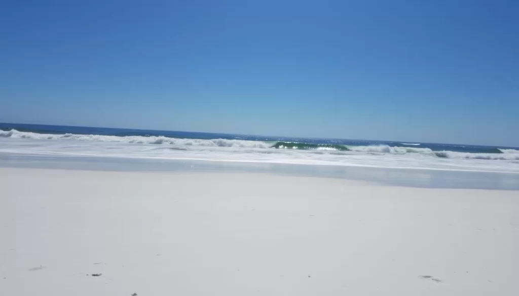Image of Gulf State Park Beach with fine white sand and crashing waves