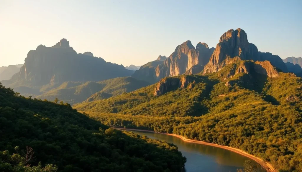 A majestic panorama of the Dângrêk Mountains in Cambodia, captured on a clear day. Towering peaks rise against a cloudless sky, their rugged slopes draped in lush, verdant foliage. In the foreground, a meandering river cuts through the landscape, its tranquil waters reflecting the mountains' timeless grandeur. Warm, golden sunlight bathes the scene, casting a soft, almost ethereal glow over the ancient, weathered rock formations. The mountains' rich history and cultural significance are palpable, hinting at the stories they have witnessed over the centuries. This serene, awe-inspiring vista conveys the majestic, timeless beauty of the Dângrêk range.