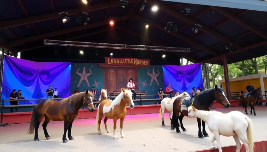Generate an image of the Land of Little Horses Theme Park main stage with performers and miniature horses.