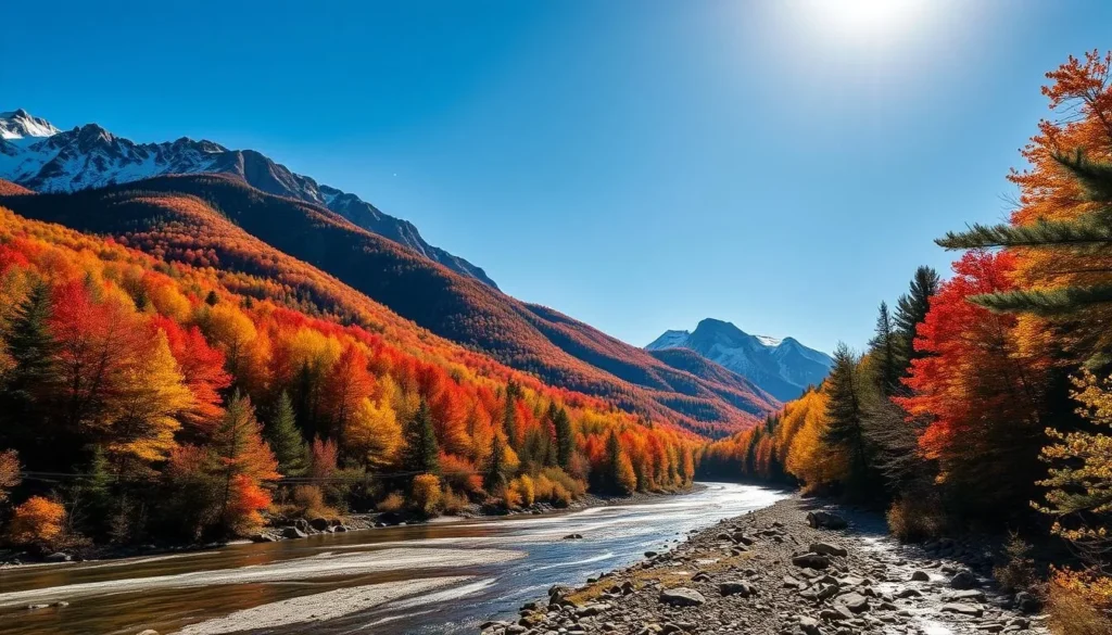 Kancamagus Highway, New Hampshire: a scenic mountain road winding through a tapestry of autumn foliage. Capture the grandeur of the White Mountains, with rugged peaks piercing a cloudless azure sky. In the foreground, a gently flowing river reflects the vibrant reds, oranges, and golds of the surrounding hardwood forest. Sunlight filters through the canopy, casting a warm, golden glow over the serene landscape. Utilize a wide-angle lens to showcase the majestic scale of this natural wonder, inviting the viewer to immerse themselves in the tranquil beauty of this quintessential New England scene.