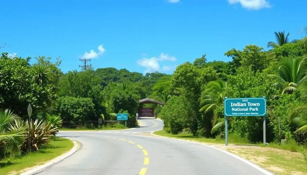 Road leading to Indian Town National Park entrance with signage and tropical vegetation Road leading to Indian Town National Park entrance with signage and tropical vegetation