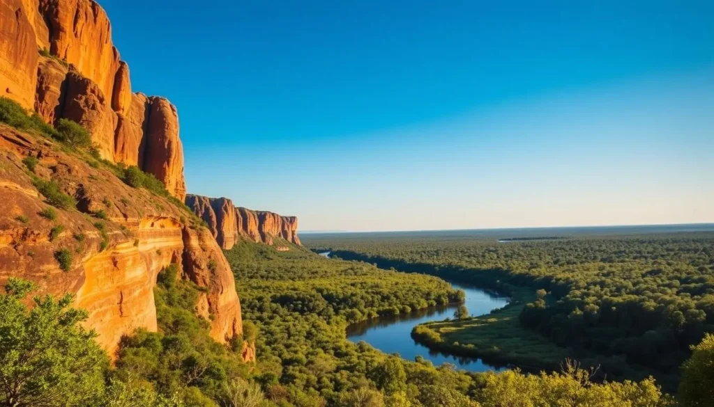 A lush, verdant landscape unfolds, showcasing the iconic Kakadu National Park. In the foreground, towering sandstone cliffs rise majestically, their rugged edges bathed in warm, golden sunlight. Meandering through the middle ground, a winding river reflects the azure sky above, its calm waters dotted with lily pads and the occasional basking crocodile. Beyond, the horizon is blanketed by a dense, vibrant rainforest, its canopy of lush, emerald foliage casting dappled shadows on the forest floor. The scene exudes a sense of tranquility and timelessness, inviting the viewer to immerse themselves in the natural wonder of this UNESCO World Heritage site.
