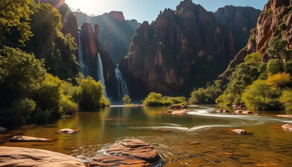 A vast, rugged landscape of towering sandstone cliffs, cascading waterfalls, and winding rivers nestled in the heart of Australia's Northern Territory. Sunlight filters through lush, verdant foliage, casting a warm, golden glow over the scene. In the foreground, a serene, crystal-clear pool reflects the dramatic escarpments surrounding it, inviting visitors to explore the hidden wonders of Nitmiluk National Park. The middle ground features a gently flowing stream, its waters sparkling as they tumble over smooth, weathered rocks. In the distance, the rugged, weathered peaks of the park's iconic gorges rise majestically, their shadows creating a sense of depth and grandeur. The overall atmosphere is one of tranquility, wonder, and the awe-inspiring power of nature.