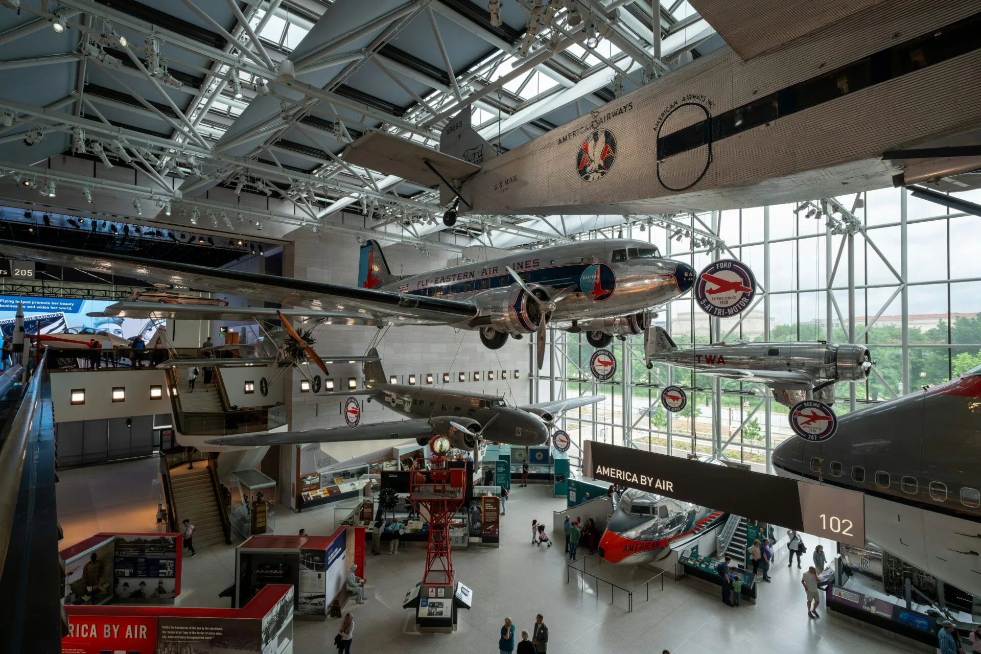 An airplane museum with people looking at planes