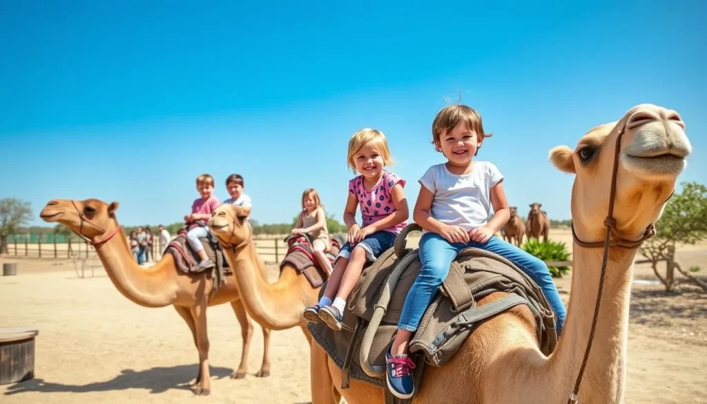 Generate an image of children riding camels at the Camel Park in Mazotos, with a smiling staff member in the background. Generate an image of children riding camels at the Camel Park in Mazotos, with a smiling staff member in the background.