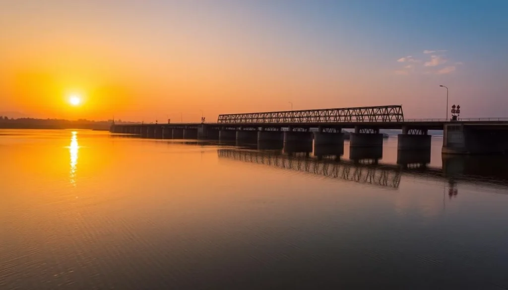 Generate an image of the Koshi Barrage with the sun setting behind it, casting a golden glow over the structure and the surrounding water.