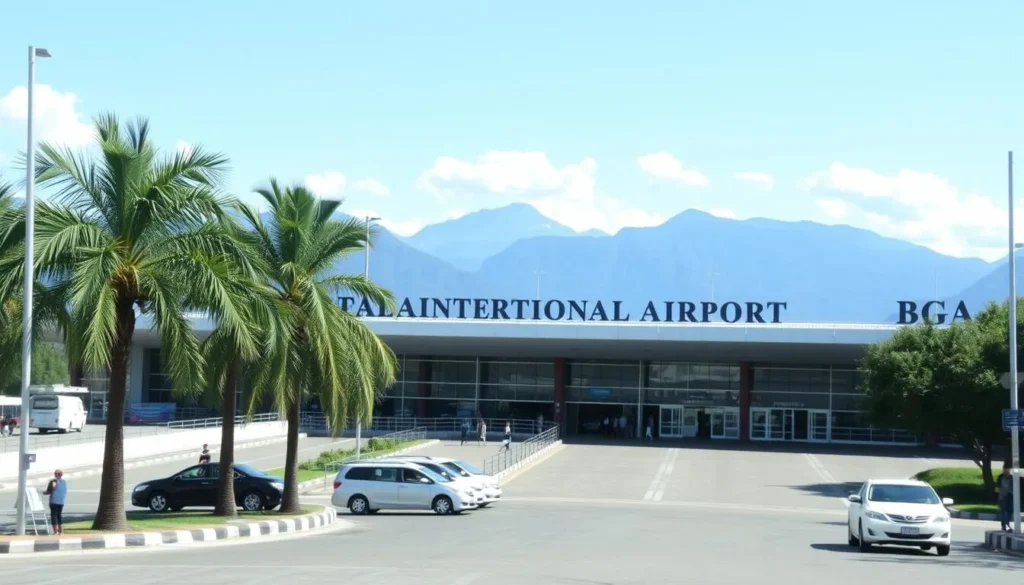 Palonegro International Airport entrance with palm trees and mountains in the background Palonegro International Airport entrance with palm trees and mountains in the background