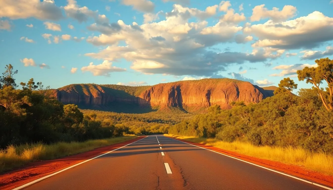 Scenic road leading into Kakadu National Park with lush greenery and dramatic escarpment in the background