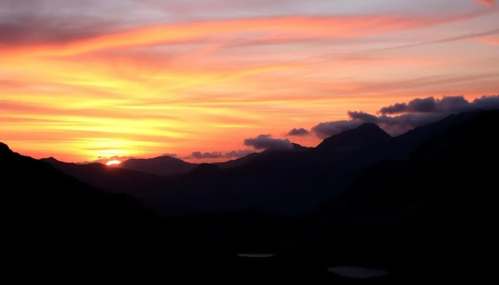 Sunset over Snowdonia National Park with mountains silhouetted against a colorful sky