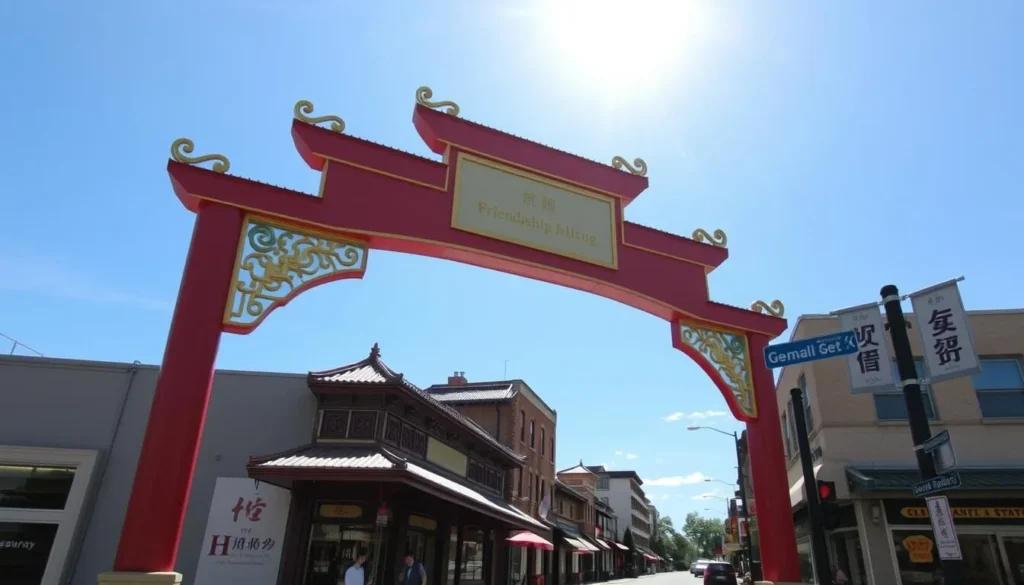 The iconic Chinatown Friendship Arch in Washington DC with Chinese restaurants visible along the street on a sunny day
