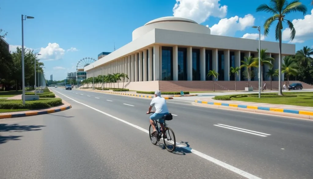 Image of a cyclist riding on a wide avenue in Brasilia with modernist architecture in the background