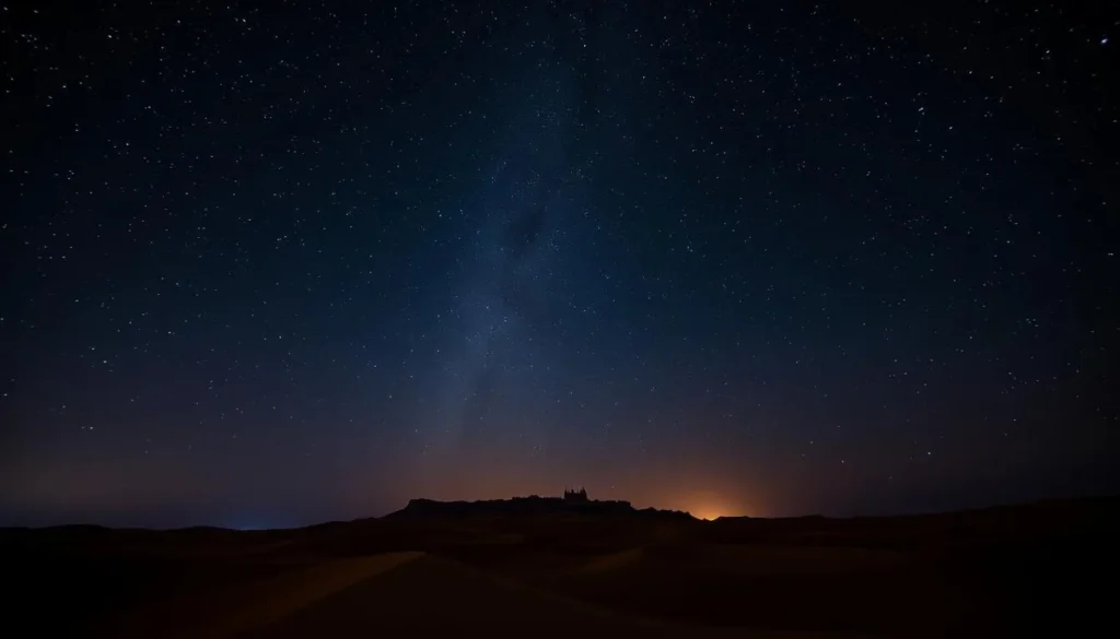 Starry night sky over desert dunes with silhouette of Jaisalmer Fort in the distance Starry night sky over desert dunes with silhouette of Jaisalmer Fort in the distance