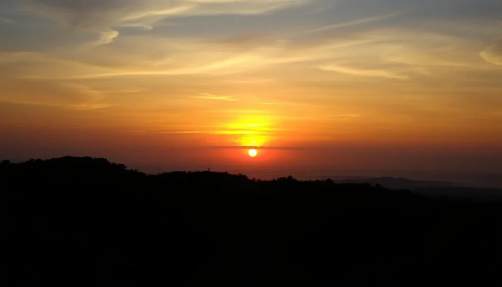 Sunset view from Himchari National Park with silhouettes of hills against orange sky Sunset view from Himchari National Park with silhouettes of hills against orange sky