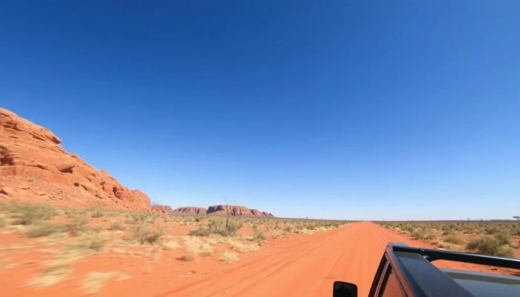 4WD vehicle on a red dirt road near Tennant Creek with outback landscape