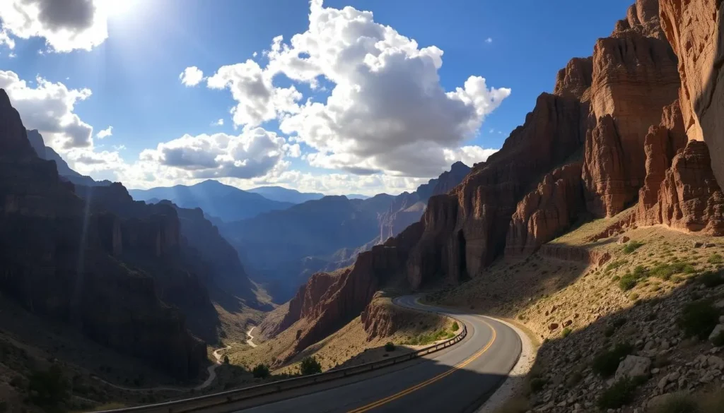 A dramatic mountain gorge with winding roads and sweeping canyon vistas. Sunlight filters through towering cliffs, casting warm golden tones across the rugged terrain. In the foreground, a well-maintained asphalt road meanders through the steep landscape, offering ample pullout areas for admiring the breathtaking scenery. Fluffy white clouds drift lazily across a vibrant blue sky, creating dynamic shadows that dance across the rock formations. The overall atmosphere is one of serene grandeur, inviting the viewer to explore this magnificent natural wonder.