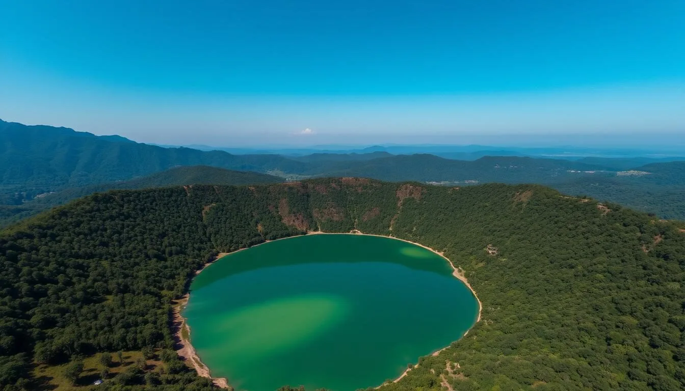 Aerial view of Nong Fa Lake (Lake Nongphatou) in Laos showing emerald waters surrounded by lush forest