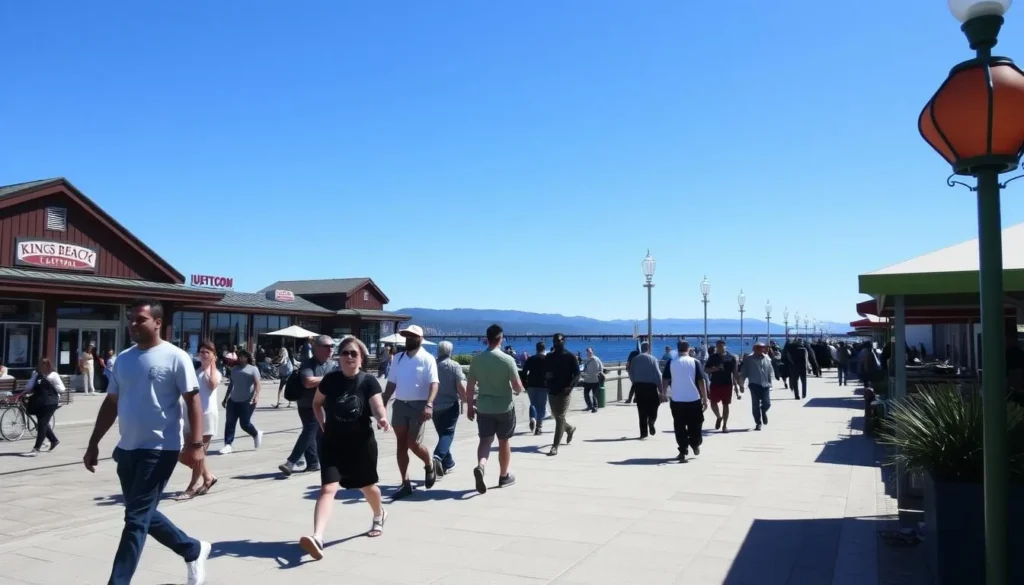 People walking along the Kings Beach waterfront promenade with shops and restaurants visible