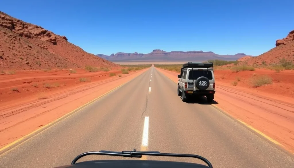 Road leading to the Macdonnell Ranges with a 4WD vehicle driving through the outback landscape