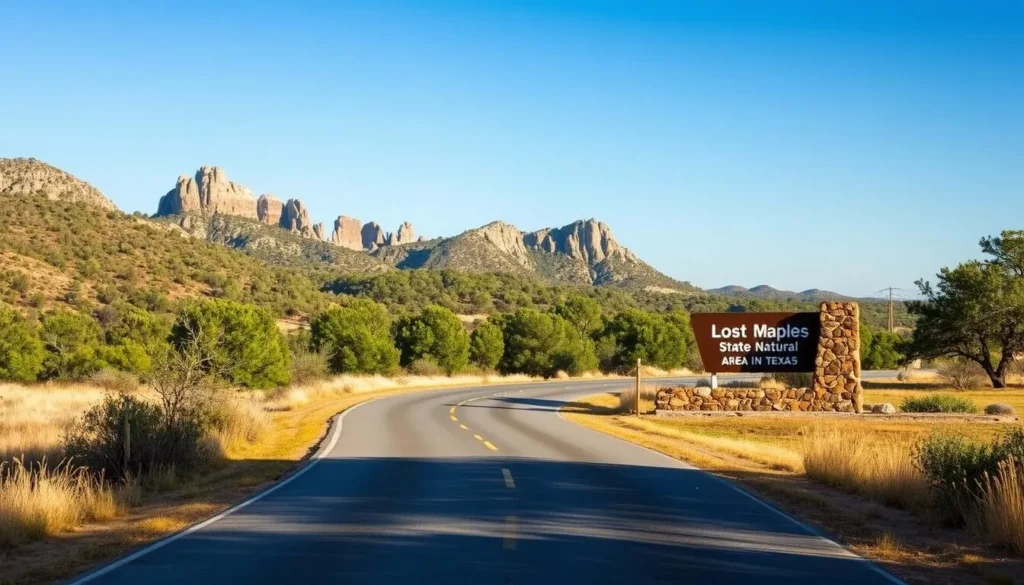 Scenic road leading to Lost Maples State Natural Area entrance with Hill Country landscape and directional sign