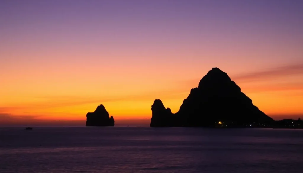 Sunset over Puerto Vallarta bay with the iconic Los Arcos rock formations