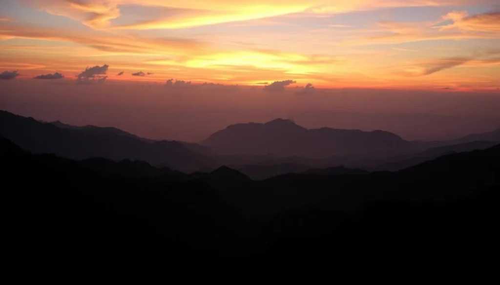 Sunset view over Ella Gap from a mountain viewpoint with silhouettes of hills