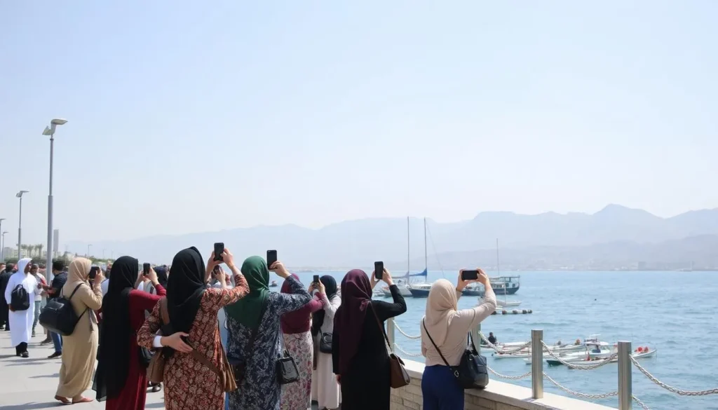 Tourist taking photos at Muttrah Corniche while respectfully dressed in modest clothing Tourist taking photos at Muttrah Corniche while respectfully dressed in modest clothing
