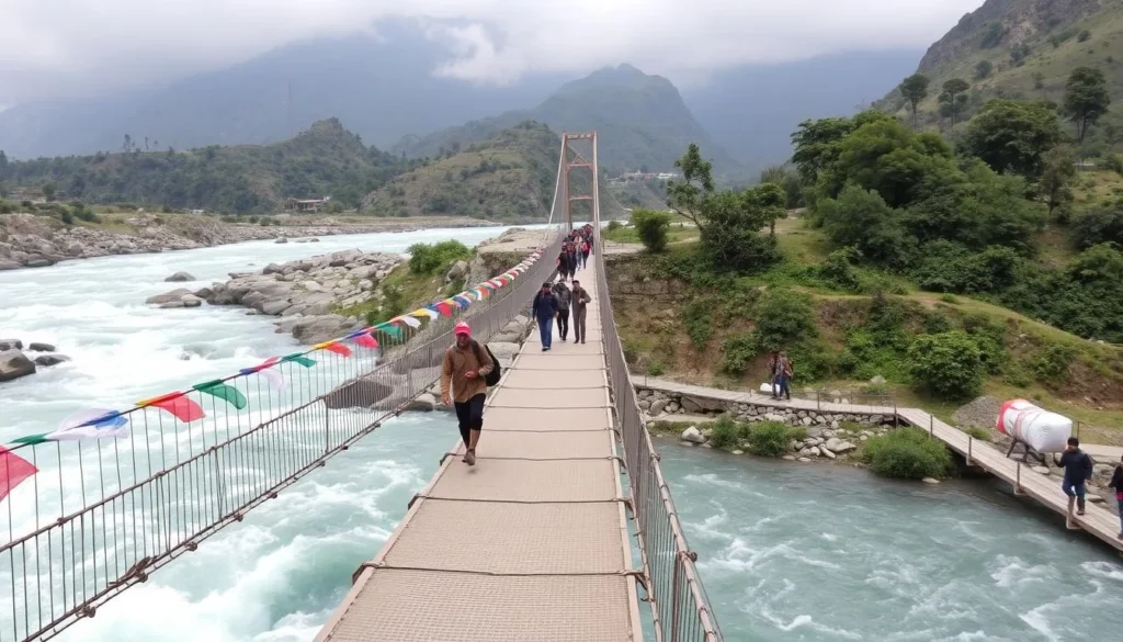 Trekkers crossing a suspension bridge over a river in the Annapurna region with porters carrying supplies