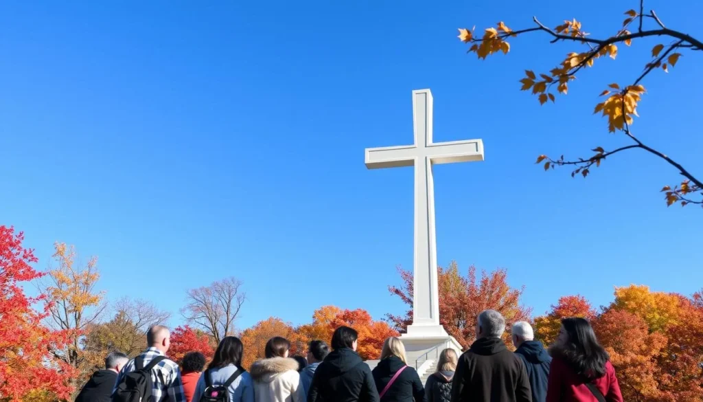 Bald Knob Cross surrounded by vibrant fall foliage in autumn with visitors enjoying the view
