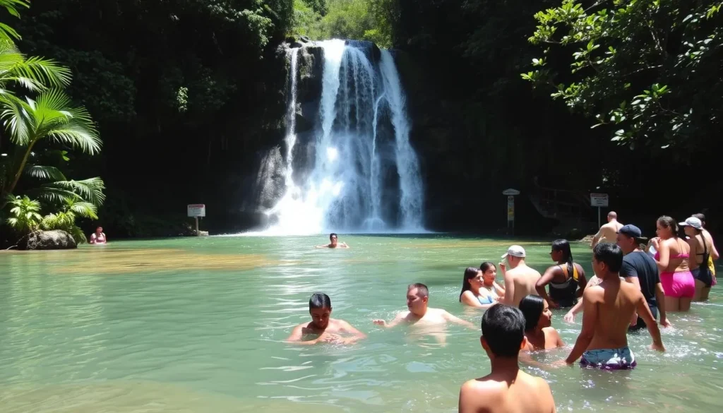 Latille Waterfall in Micoud, St. Lucia with tourists enjoying the natural pool