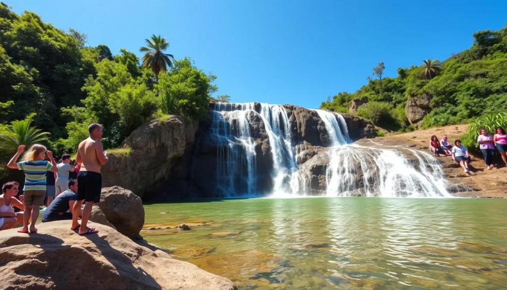 Mount Kopinang waterfall during dry season with clear water flow and tourists enjoying the view