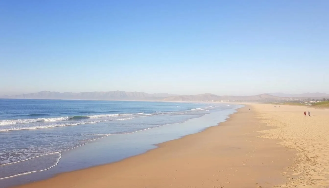 Panoramic view of Carpinteria State Beach showing the gentle shoreline and mountains in the background
