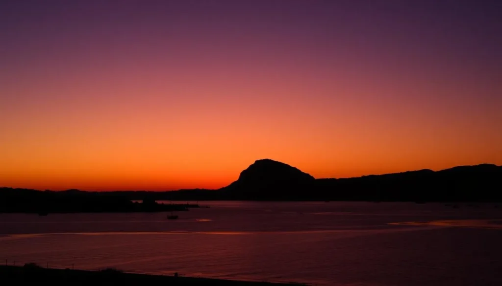 Sunset view over Morro Bay with silhouette of Morro Rock and boats in the harbor Sunset view over Morro Bay with silhouette of Morro Rock and boats in the harbor