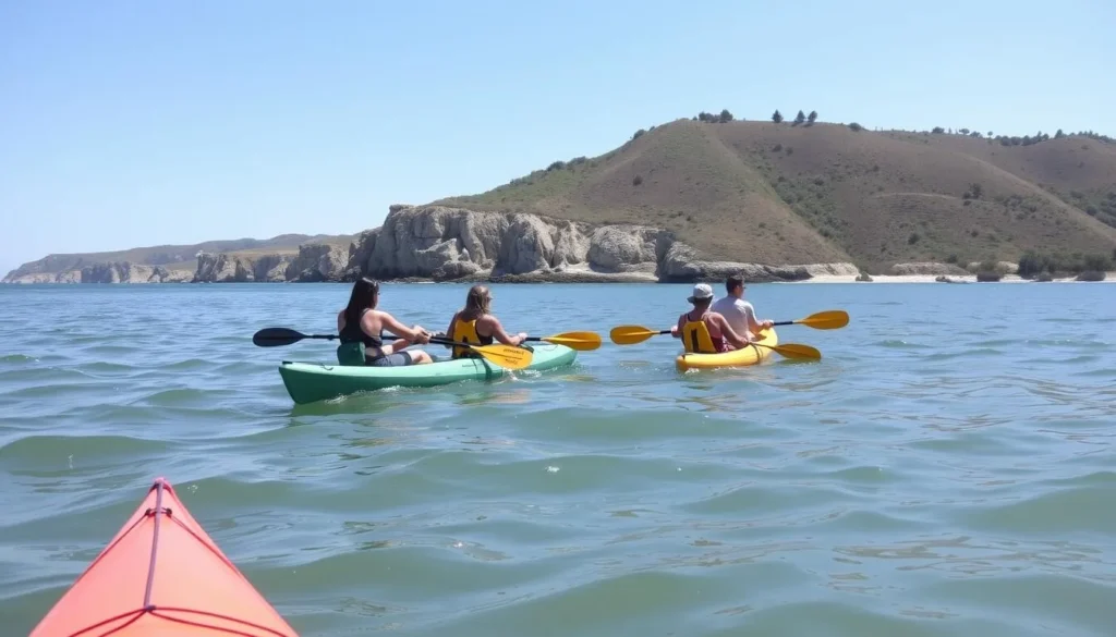 Visitors kayaking near Hearst San Simeon State Park California with coastal cliffs in background Visitors kayaking near Hearst San Simeon State Park California with coastal cliffs in background