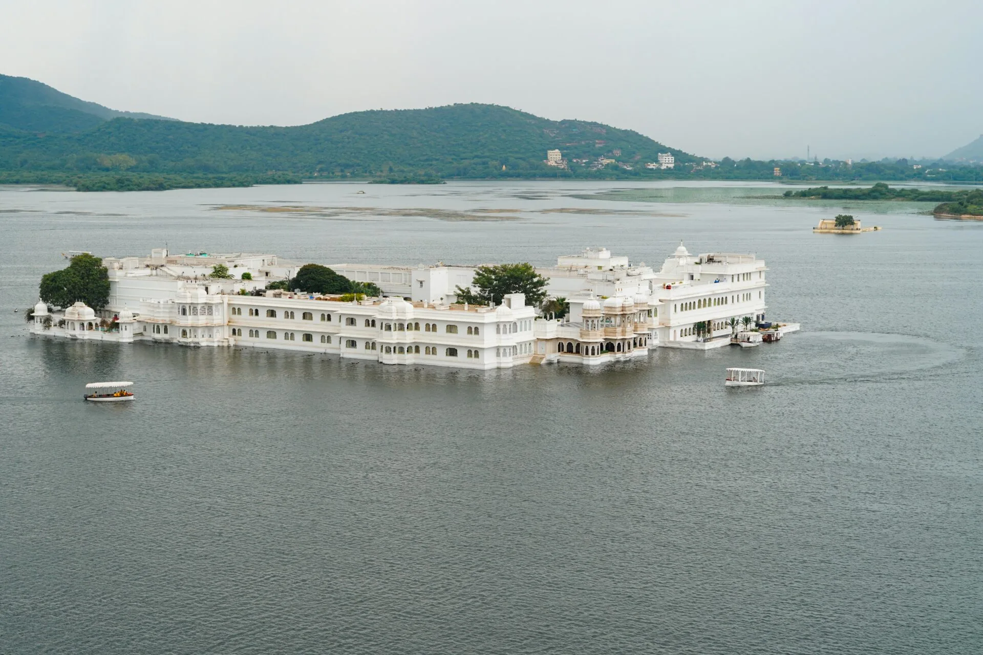 a-large-white-building-sitting-on-top-of-a-lake a large white building sitting on top of a lake