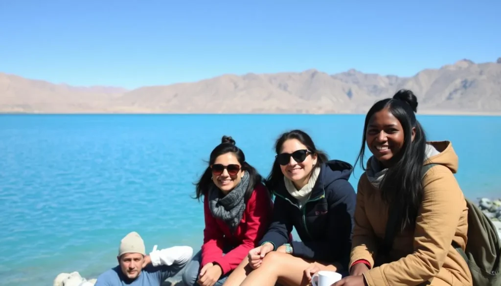 Happy diverse travelers enjoying the view of Pangong Lake with mountains in the background in Ladakh Happy diverse travelers enjoying the view of Pangong Lake with mountains in the background in Ladakh