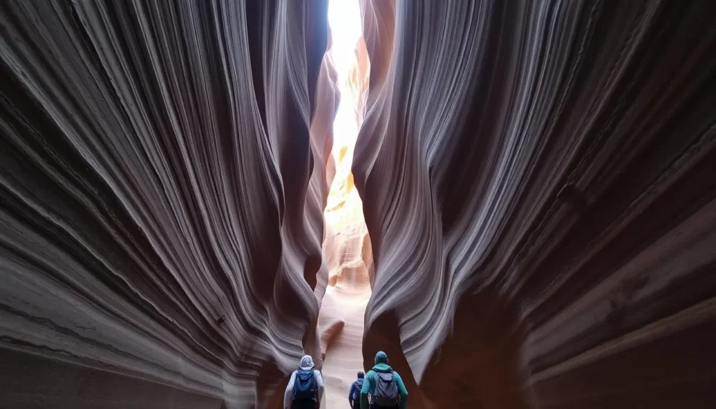 Hikers traversing the narrow passages of Buckskin Gulch slot canyon Hikers traversing the narrow passages of Buckskin Gulch slot canyon