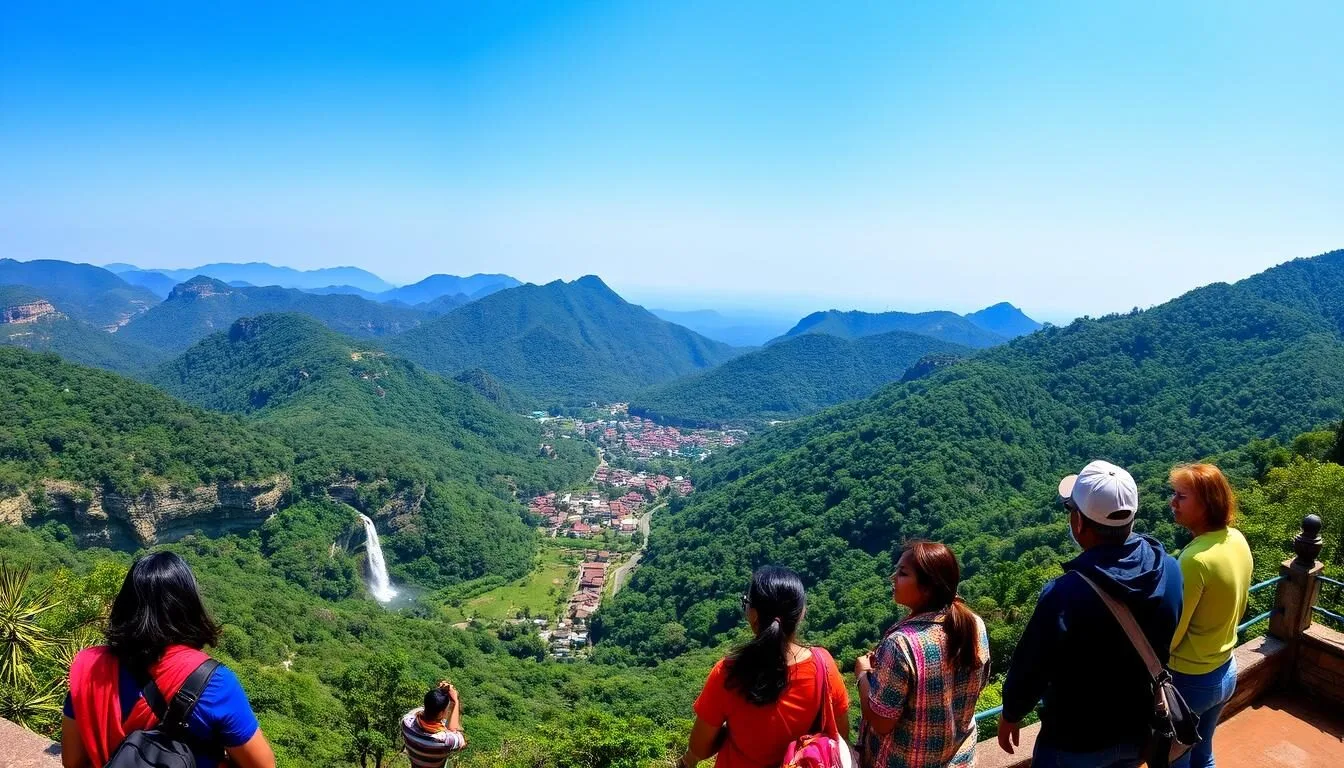 Panoramic view of Pachmarhi hill station surrounded by lush Satpura mountains with waterfalls visible in the distance