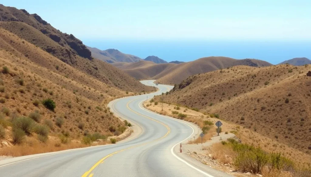 Scenic mountain road winding through Santa Monica Mountains with ocean views