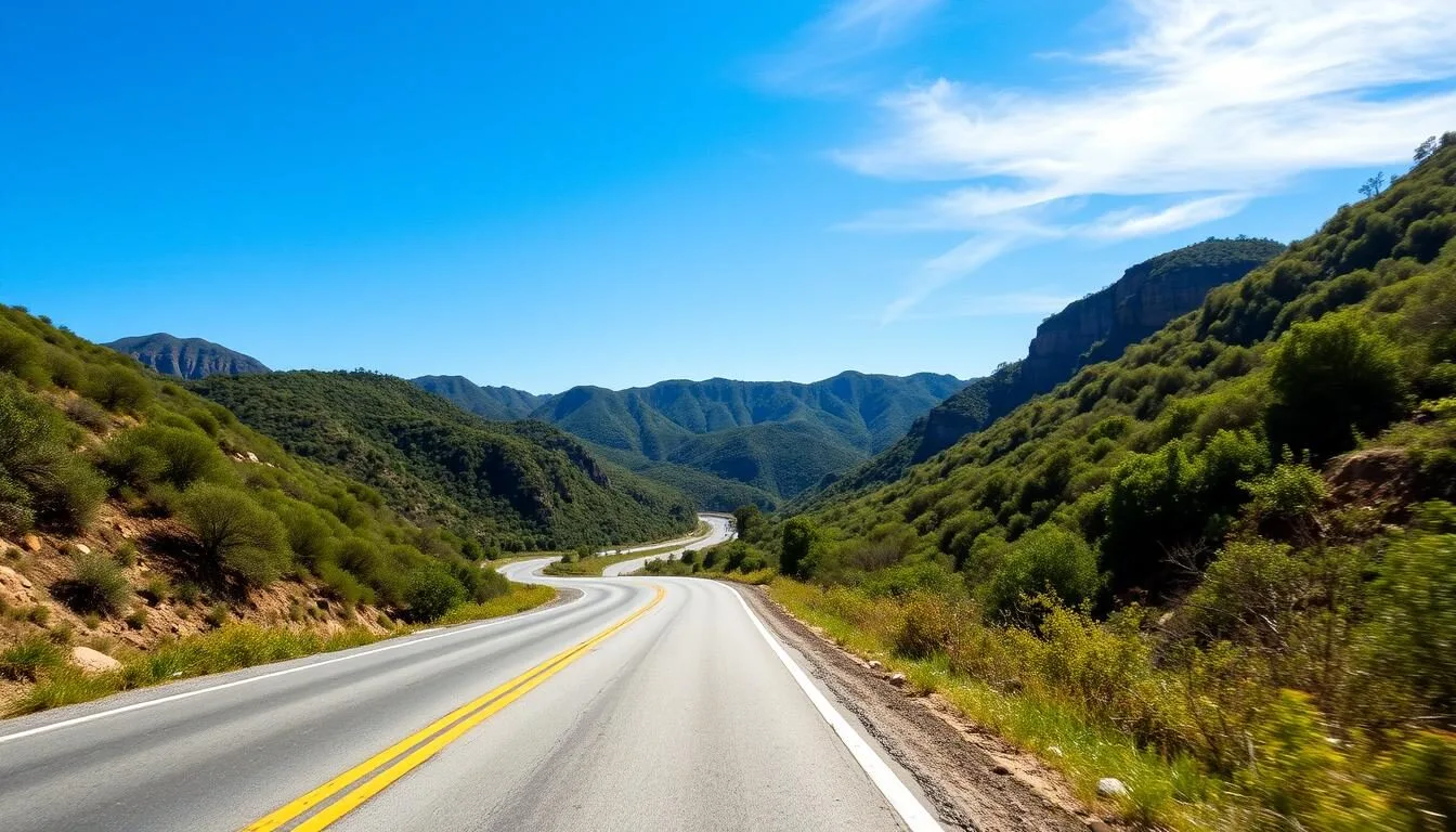 Scenic view of Topanga Canyon road winding through the Santa Monica Mountains with lush vegetation on a clear day
