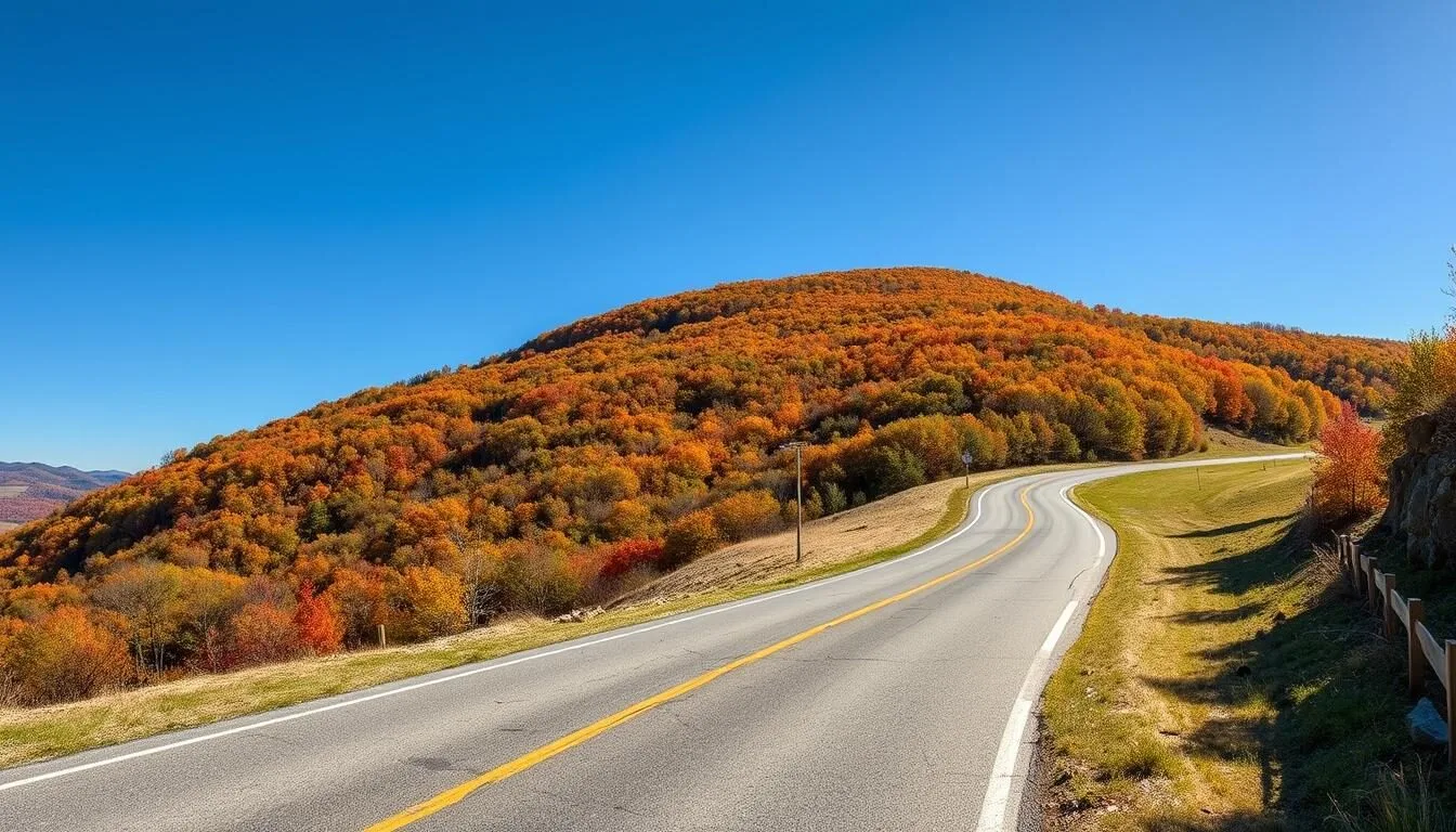 Scenic view of Wills Mountain with autumn foliage and winding road approaching the mountain