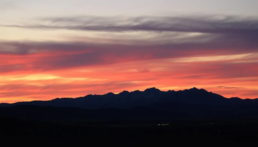 Sunset over the Front Range mountains with city lights beginning to twinkle below