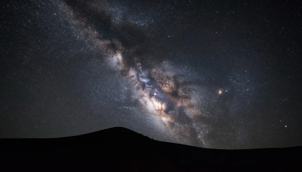 Brilliant Milky Way galaxy stretching across night sky above Great Basin mountain silhouette