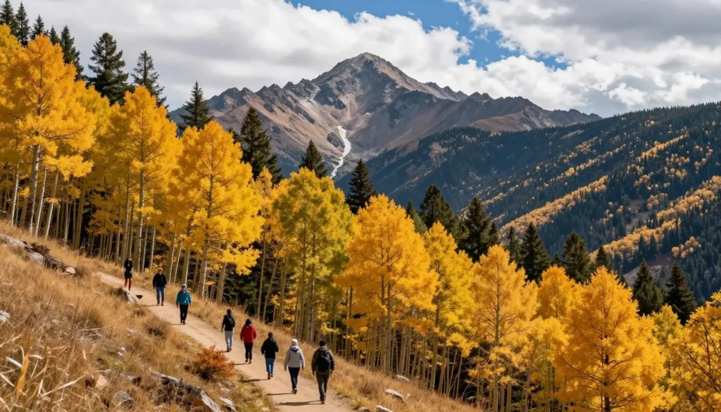 Pikes Peak summit covered in autumn colors with aspen trees displaying golden yellow foliage along the mountain slopes Pikes Peak summit covered in autumn colors with aspen trees displaying golden yellow foliage along the mountain slopes