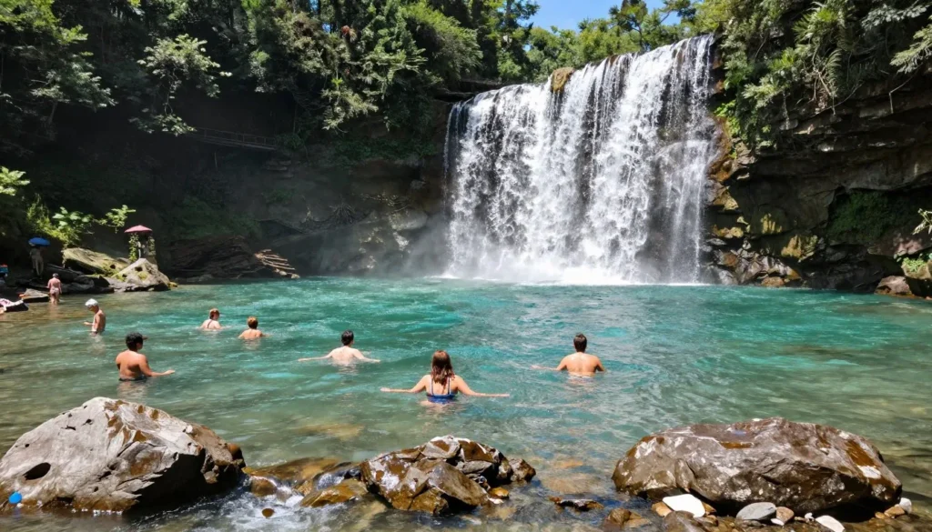 Crystal clear swimming hole beneath waterfall at Gar Island Tennessee with visitors enjoying the water Crystal clear swimming hole beneath waterfall at Gar Island Tennessee with visitors enjoying the water