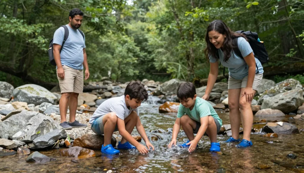 Diverse family with children exploring mountain stream with rocks and shallow water in Great Smoky Mountains Diverse family with children exploring mountain stream with rocks and shallow water in Great Smoky Mountains