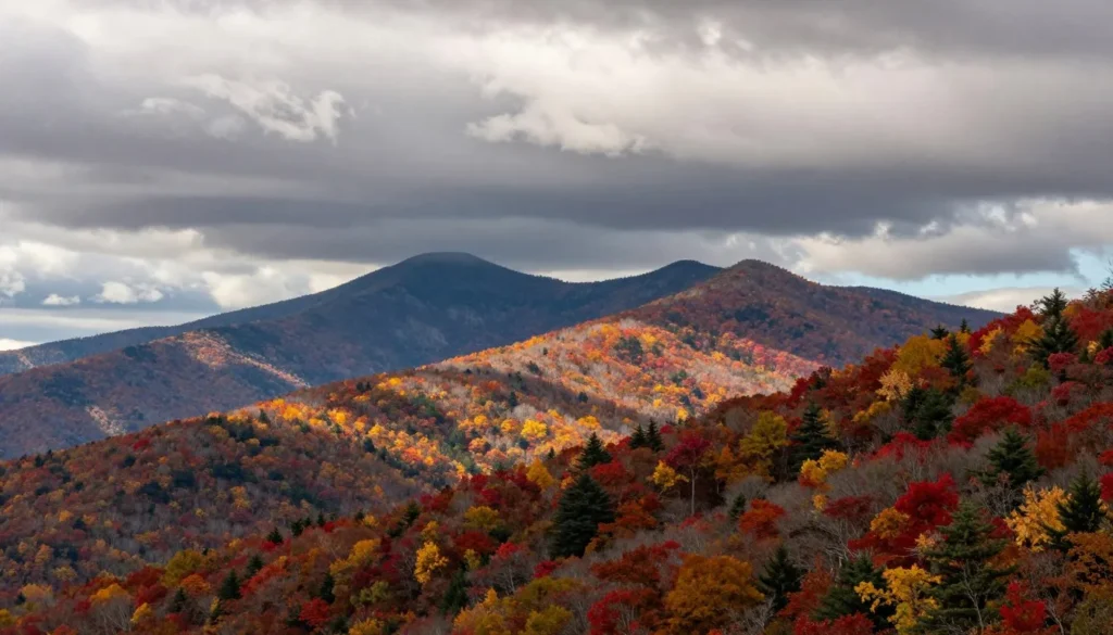Grandfather Mountain seasonal view showing mixed weather conditions across mountain slopes with autumn colors Grandfather Mountain seasonal view showing mixed weather conditions across mountain slopes with autumn colors