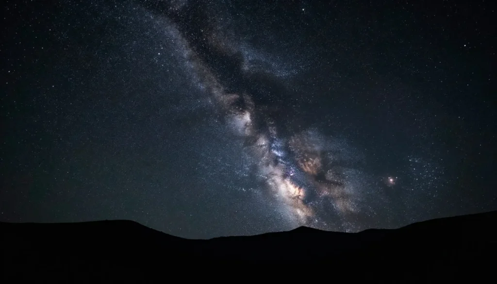 Night sky with stars over mountain silhouette