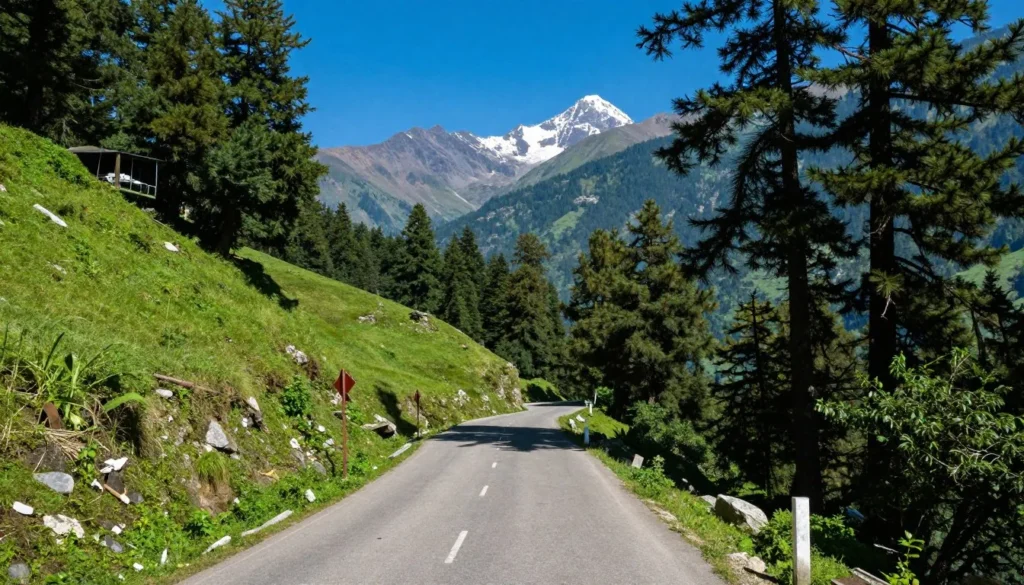 Scenic mountain road winding through green hills leading to Gangtok