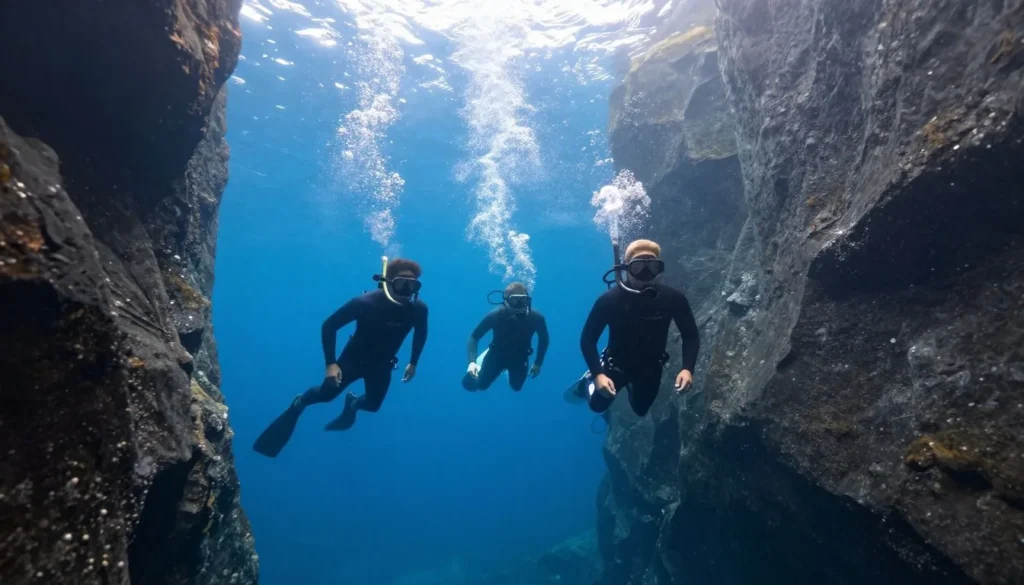 Three snorkelers in Silfra fissure at Thingvellir National Park Iceland Three snorkelers in Silfra fissure at Thingvellir National Park Iceland